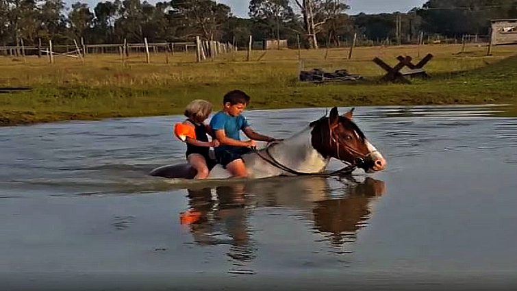 Brother and sister on horse together