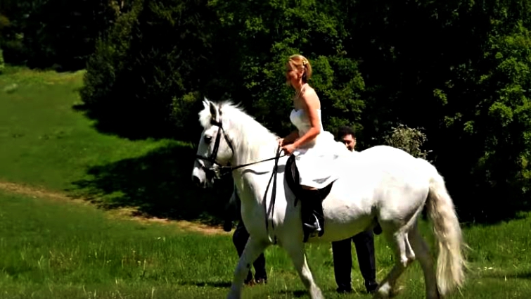 Bride arriving on horseback at wedding